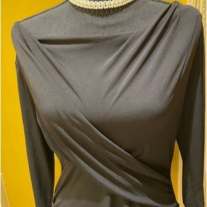 Black dress up or dress down top very comfortable/washes well.